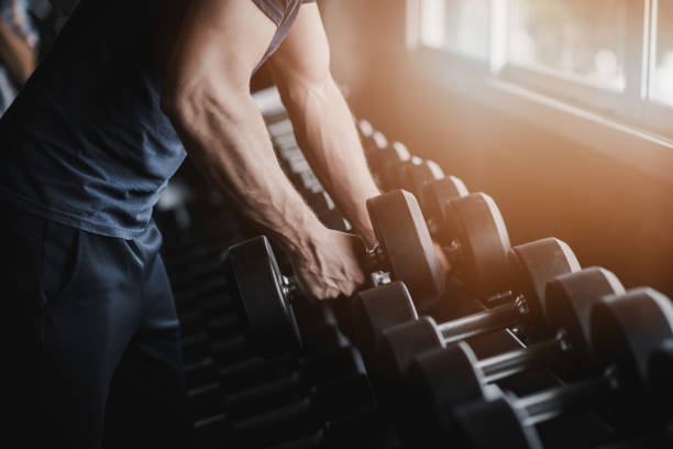 istock sport man gym bodybuilding closeup. 1005853272