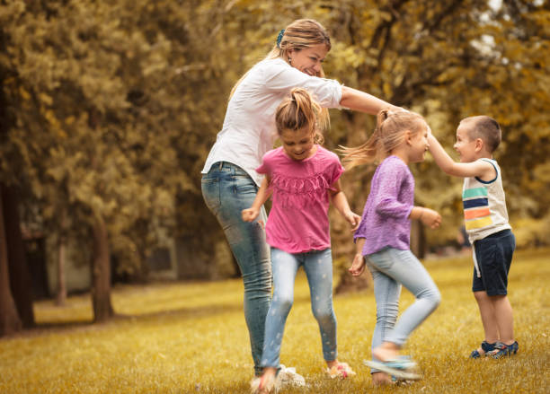 istock Time for playing with teacher. Group of children. 1005854312
