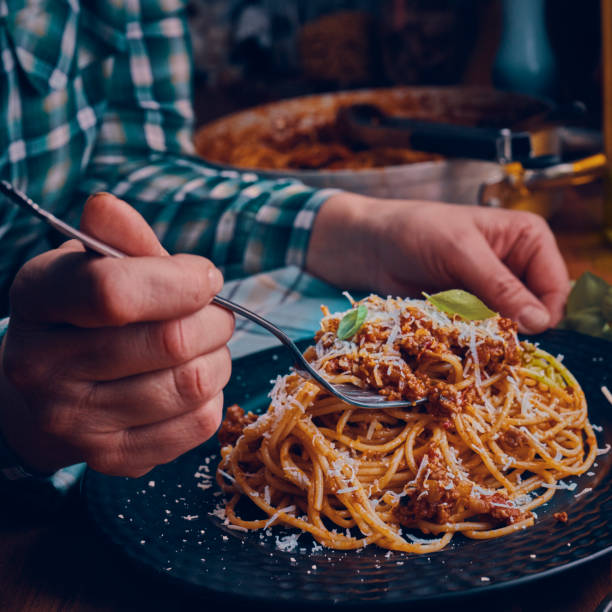 istock Eating Homemade Spaghetti Bolognese 1005860590