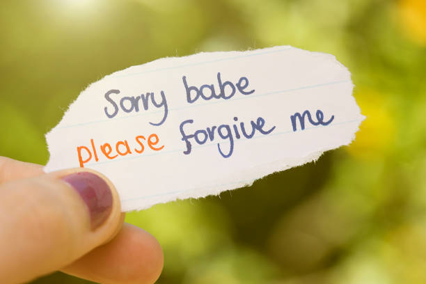 istock Female hand holds apologetic note 