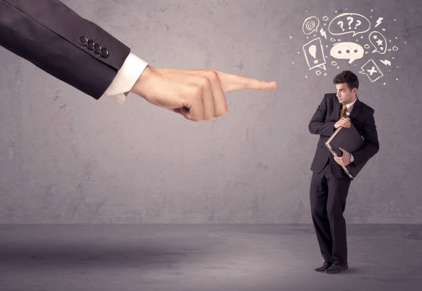 istock Boss hand pointing at confused employee 1005863916