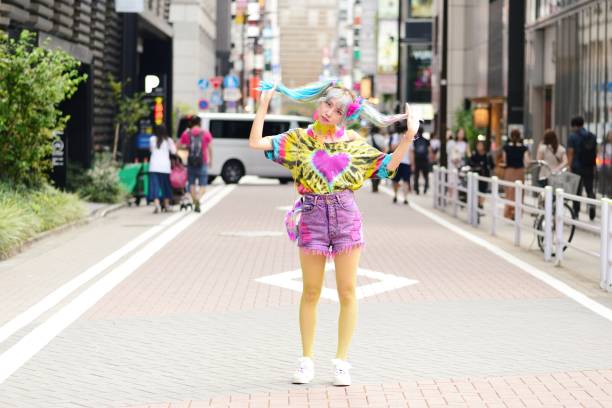 A unique-looking young woman striking a pose for the camera while standing outside.