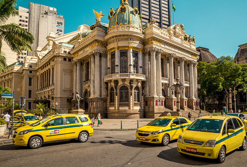 Rio De Janeiro, Brazil - December 15, 2017: Street full of taxi cars with Theatro Municipal in the background in Rio de Janeiro, Brazil