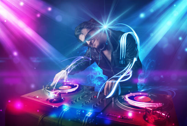 istock Energetic Dj mixing music with powerful light effects 1005867758