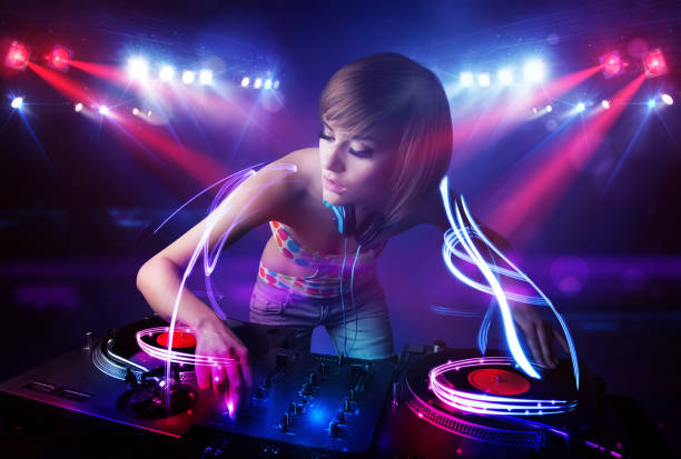 istock Disc jockey girl playing music with light beam effects on stage 1005867896