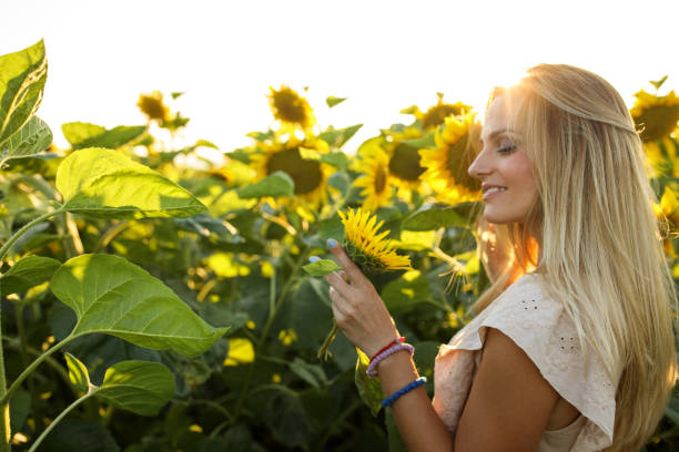 istock Happy woman in sunflower field 1005870992