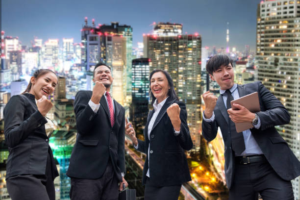 istock Professional group business person arm raised up be glad with successful on glowing light in the city 1005871426