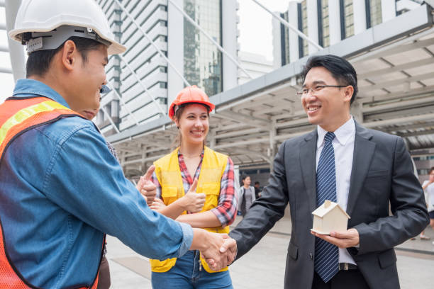 istock Engineer group handshake agreement with businessman for project residential construction 1005871460