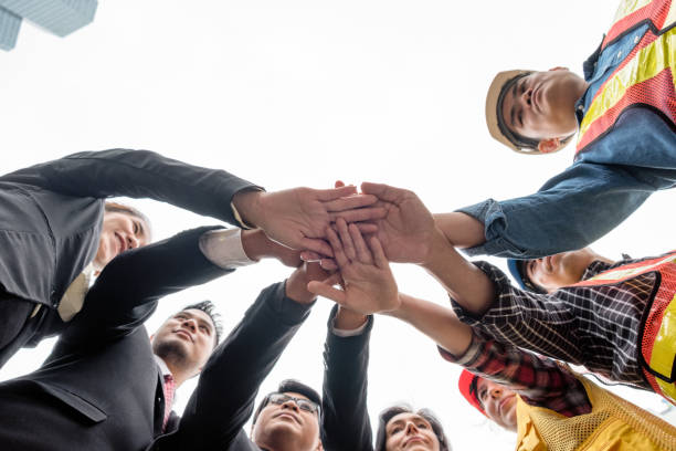 istock Business person with engineer group take coordination hands stacked 1005871462