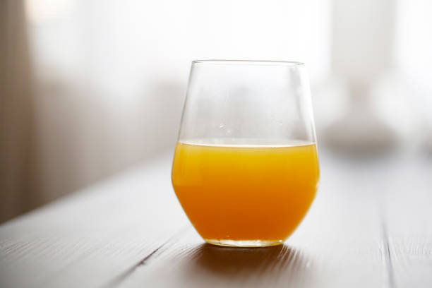 Sugarcane juice with piece of sugarcane on wooden background. Close up, Select focus.