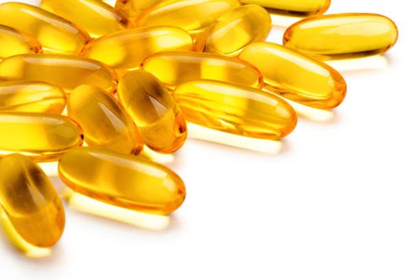 istock Pile of capsules Omega 3 on white background 1005881214