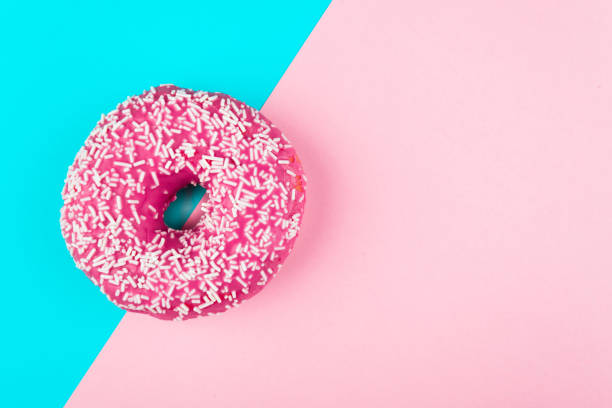 istock one pink isolated donut on a mint and pink background 1005881322