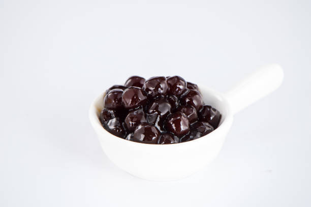 istock black pearls. Boiled tapioca pearls for bubble tea on white background. Copy space 1005881904