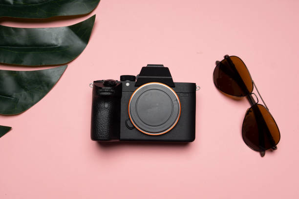 istock a sunglasses an a camera on a pink background 1005881934