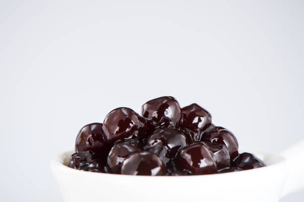 istock black pearls. Boiled tapioca pearls for bubble tea on white background. Copy space 1005881948