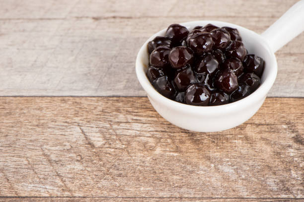 istock Tapioca Pearl , Bubble topping for tea or other beverage, in a cup, place on wooden table. Copy space 1005882062