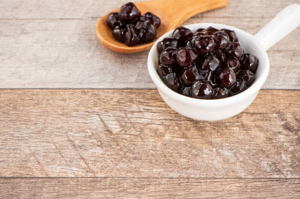 istock Tapioca Pearl , Bubble topping for tea or other beverage, in a cup, place on wooden table. Copy space 1005882090