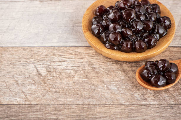 istock Tapioca Pearl , Bubble topping for tea or other beverage, in a cup, place on wooden table. Copy space 1005882096