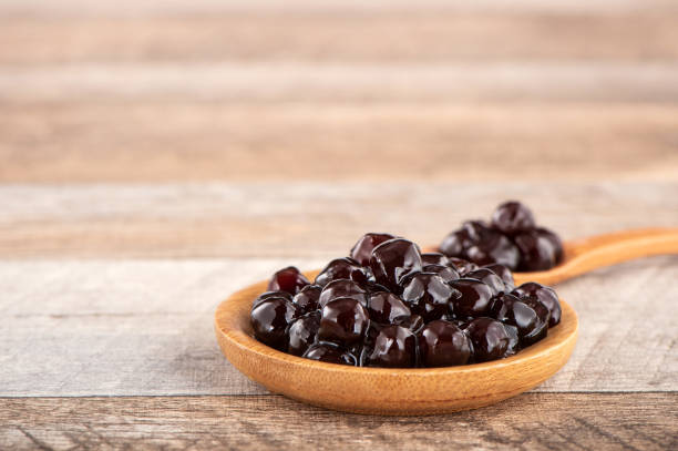 istock Tapioca Pearl , Bubble topping for tea or other beverage, in a cup, place on wooden table. Copy space 1005882114