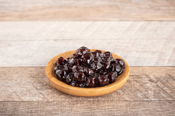 istock Tapioca Pearl , Bubble topping for tea or other beverage, in a cup, place on wooden table. Copy space 1005882124