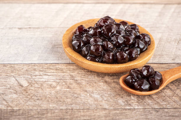 istock Tapioca Pearl , Bubble topping for tea or other beverage, in a cup, place on wooden table. Copy space 1005882126