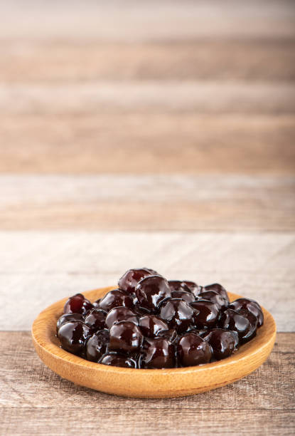 istock Tapioca Pearl , Bubble topping for tea or other beverage, in a cup, place on wooden table. Copy space 1005882164