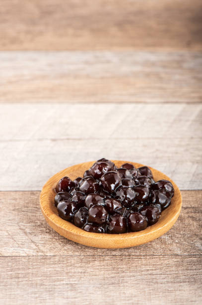 istock Tapioca Pearl , Bubble topping for tea or other beverage, in a cup, place on wooden table. Copy space 1005882176