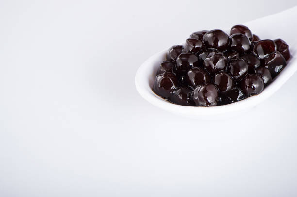 istock black pearls. Boiled tapioca pearls for bubble tea on white background. Copy space 1005882224