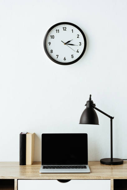 istock laptop with books and table lamp on work desk at office 1005882704