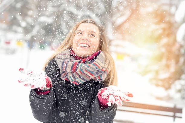 istock Cheerful young woman having fun on snow 1005882786