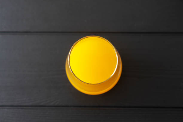 glass of fresh orange juice on table