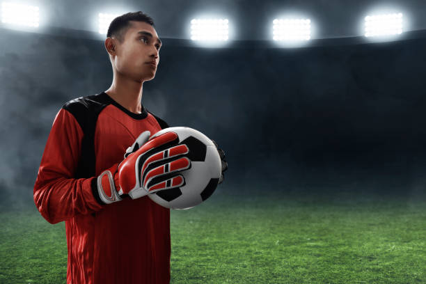 istock Soccer goalkeeper holding soccer ball 1005889828