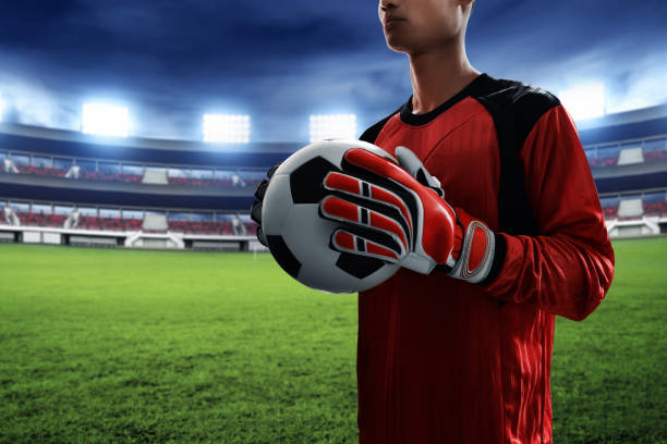 istock Soccer goalkeeper holding soccer ball 1005889830