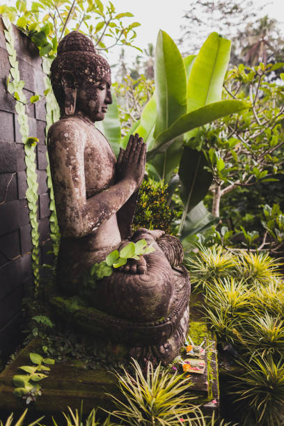 istock Big ancient stone Buddha statue in balinese garden 1005893132