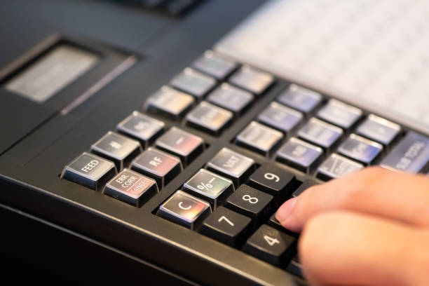 istock cash register installed on counter for accepting order from customer.sales man entering amount on electronic cash register in coffee shop and retail store.restaurant cashier typing on cash register. 1005893566