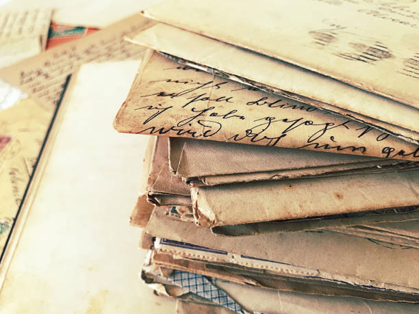 istock Close up pack of old letters over journal 1005893772