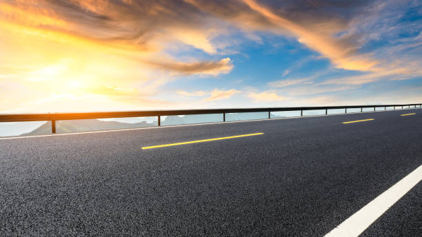 istock Asphalt highway and mountain landscape at sunset 1005900932