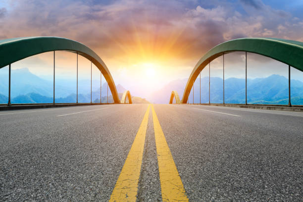 istock Asphalt highway and mountain landscape at sunset 1005900936