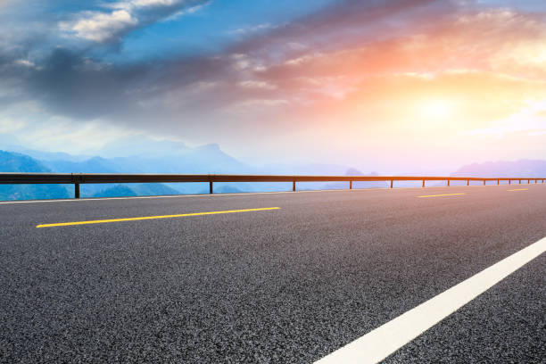 istock Asphalt highway and mountain landscape at sunset 1005903016