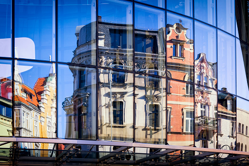 XIX century tenement house in the reflection of a shop window, Katowice, Poland