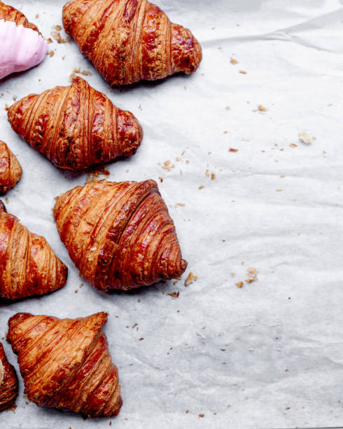 istock Croissants.  Fresh croissants on a bright background with copyspace for text. Flat lay. French bakery concept.