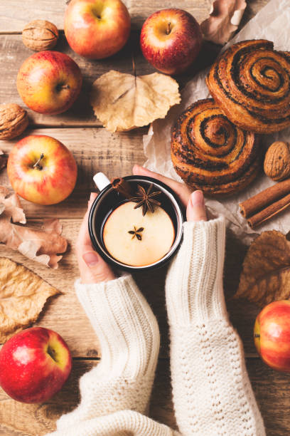 istock Traditional mulled wine in mug holding female hand 1005918496