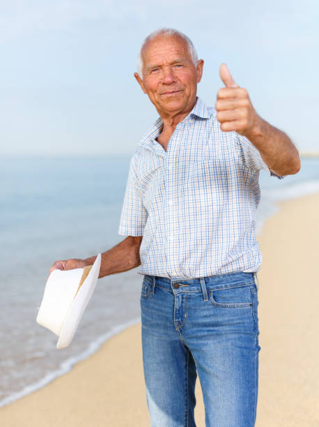 istock Satisfied elderly man giving thumbs up 1005927496