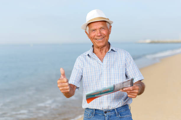 istock Satisfied cheerful mature man giving thumbs up 1005927528