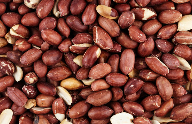 istock raw peanuts scattered as a background. place for text. a nutritious vegan snack. 1005927584