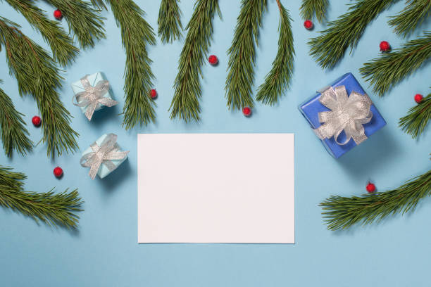 istock Christmas ore New Year background with blank note, fir branches and gifts 1005928038