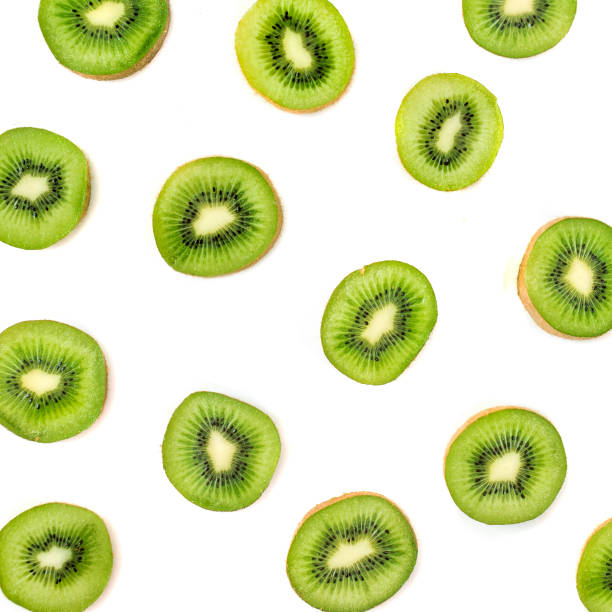 istock Kiwi fruit pattern.  Slices of ripe Kiwi fruit isolated on white background. Fresh tropical abstract background 1005931622