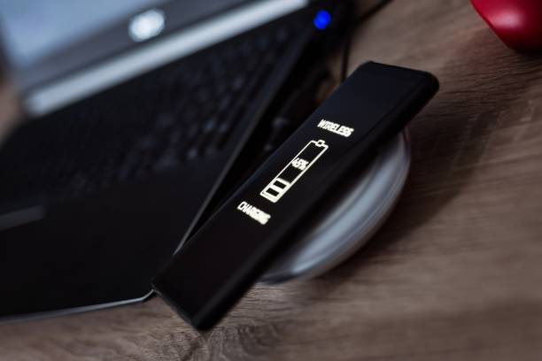 istock Cellphone wireless charging on induction charger. 1005934250