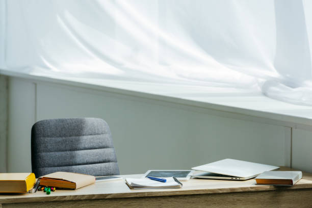 istock digital tablet, laptop and books on wooden table 1005935198