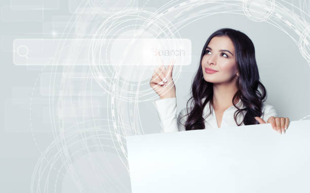 istock Successful business woman pointing to empty address bar in virtual web browser. Seo, internet marketing and distance learning concept 1005935754